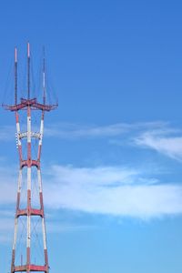 Low angle view of communications tower against blue sky