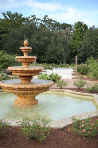 Fountain in front of swimming pool against sky