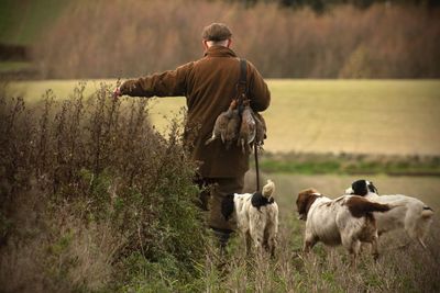 Rear view of man standing on field