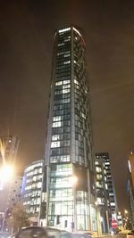 Low angle view of modern building against sky at night