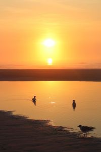 Scenic view of sea against orange sky