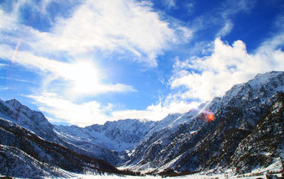 Scenic view of mountains against cloudy sky