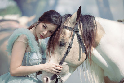 At sunset, a beautiful sensual girl and her horse go through the woods. horses are adored by girls.