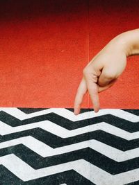 Close-up of baby hand against wall