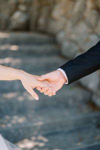 Cropped image of couple holding hands