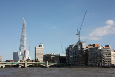 View of bridge and buildings against sky