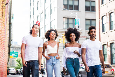 Portrait of smiling young couple in city