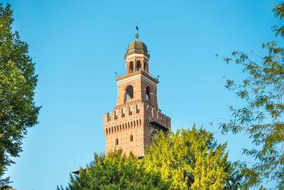 View to central tower of sforza castle at blue sky background. milan, italy