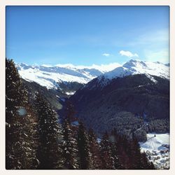 Scenic view of snow covered mountains against sky