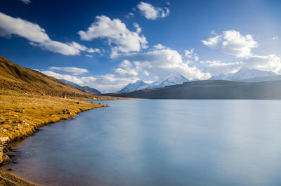 Scenic view of lake and mountains against sky