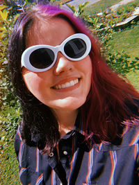 Portrait of smiling young woman wearing sunglasses