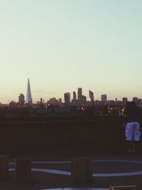 Buildings in city against clear sky