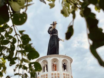 Low angle view of statue against cloudy sky