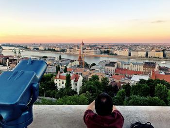 Rear view of man looking at hungarian parliament building against sky