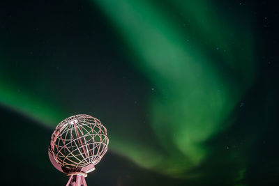 Low angle view of illuminated lighting against sky at night