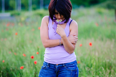 Young woman standing on grass