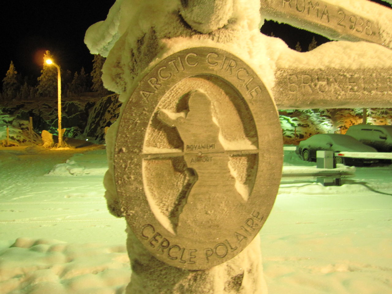 CLOSE-UP OF SNOW ON ILLUMINATED CITY STREET BY BUILDING