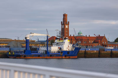 Commercial dock by pier against sky