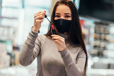 Portrait of a woman holding camera