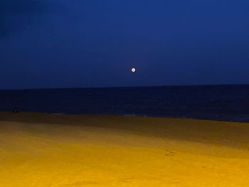 Scenic view of sea against clear sky at night