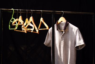 Clothes drying on clothesline against black background