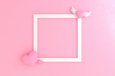 Directly above shot of red heart shape on yellow background