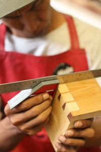 Close-up of carpenter measuring wood