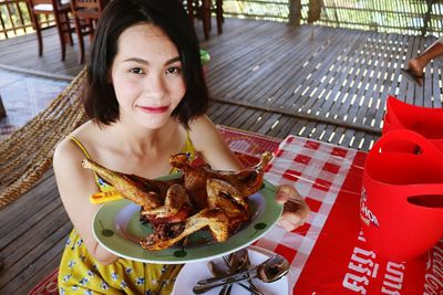 Portrait of young woman eating food