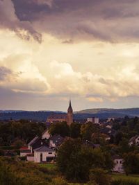 View of town against cloudy sky