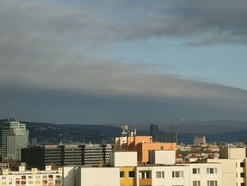 Buildings in city against sky during sunset