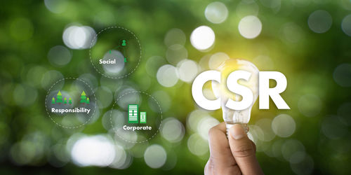 Digital composite image of text against hand holding light bulb