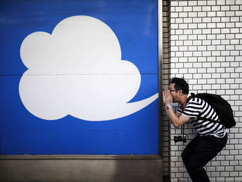 Optical illusion of man blowing cloud