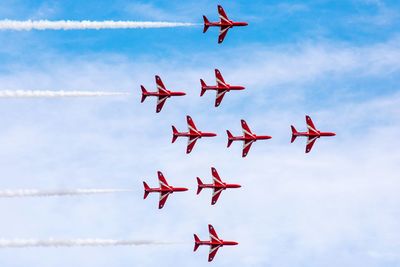 Low angle view of airshow against sky