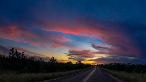 Scenic view of road against dramatic sky