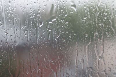 Full frame shot of wet glass window during rainy season