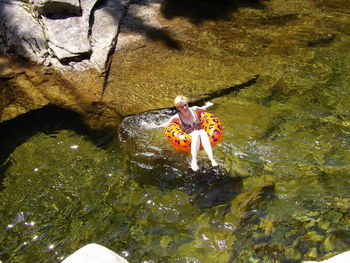 High angle view of woman swimming in lake