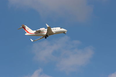 Low angle view of airplane flying against sky