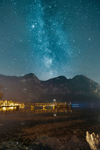 Scenic view of illuminated field against sky at night