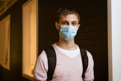 Guy in a protective mask with a backpack