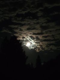 Low angle view of silhouette moon against sky at night