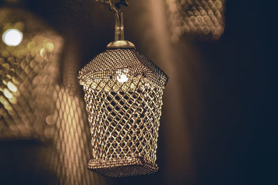 Close-up of illuminated lamp hanging on table