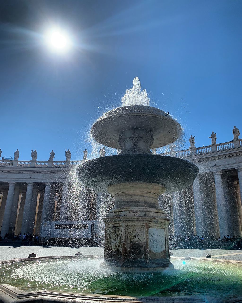 FOUNTAIN IN CITY AGAINST SKY