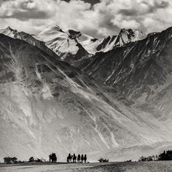 Scenic view of mountains against cloudy sky