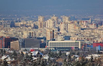 High angle view of buildings in city against sky