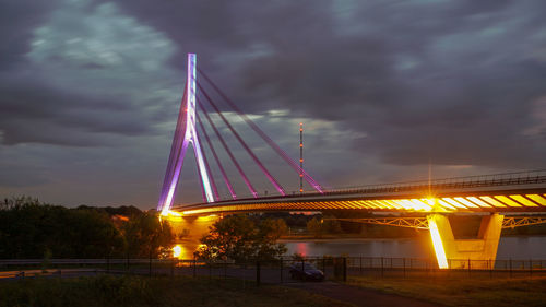 Low angle view of illuminated bridge against sky during sunset