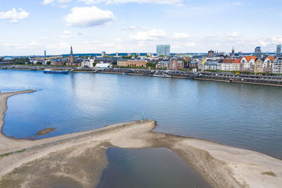 Bridge over river against buildings in city