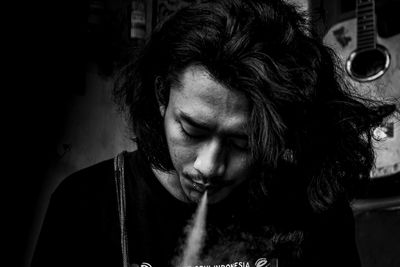 Close-up of young man smoking cigarette