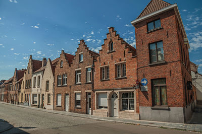 Facade of old houses in street of bruges. a town full of canals and old buildings in belgium.
