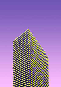 Low angle view of modern building against pink sky