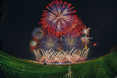 Low angle view of firework display at night